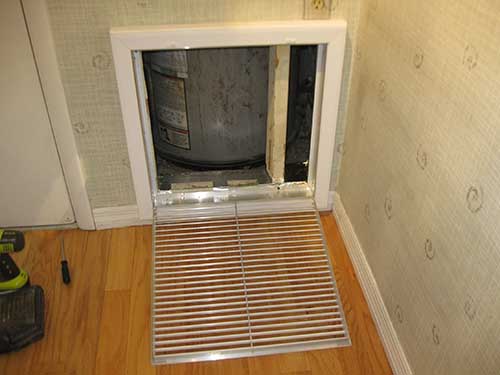 Frame installed and aluminum HVAC tape used to seal vent opening from the wall cavity.